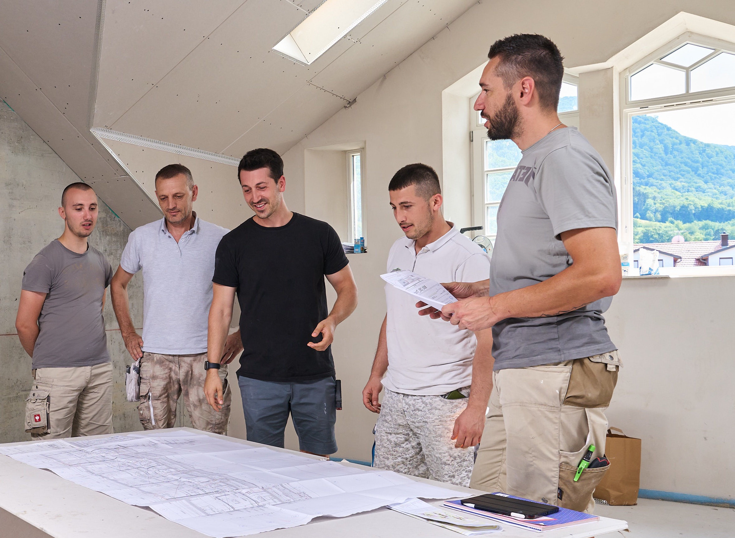 Team Baustelle Besprechung Pläne Handwerk